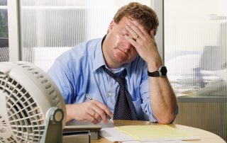 Fan blowing on a businessman