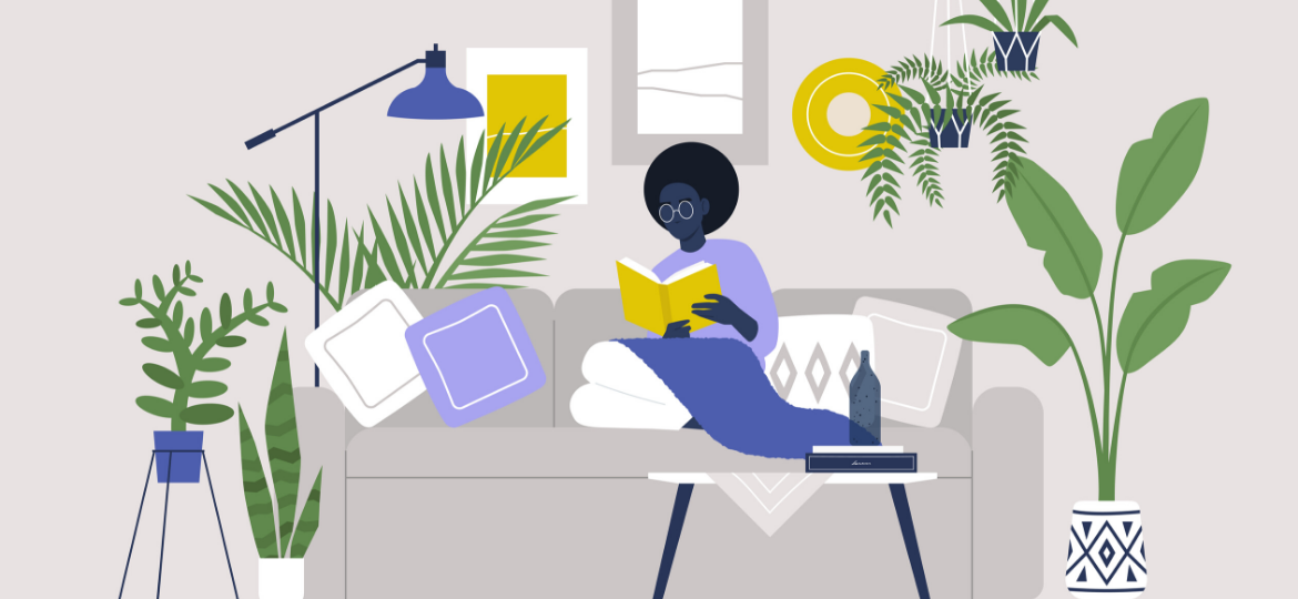 A woman is reading on a couch, surrounded by plants