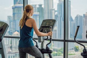 Woman exercising on elliptical in multi-family building