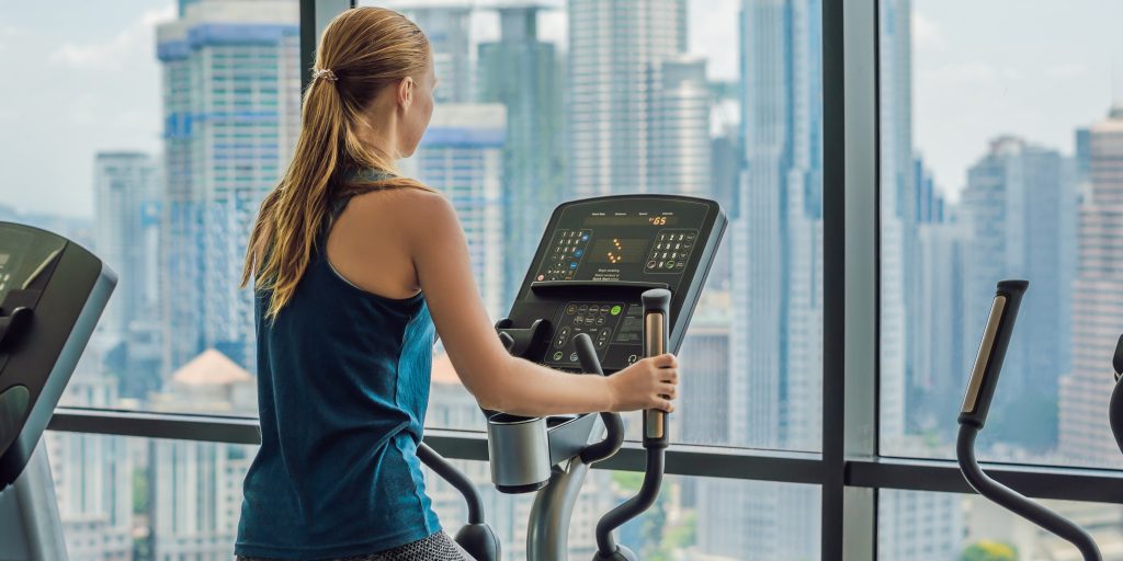 Woman exercising on an elliptical in a multi-family building