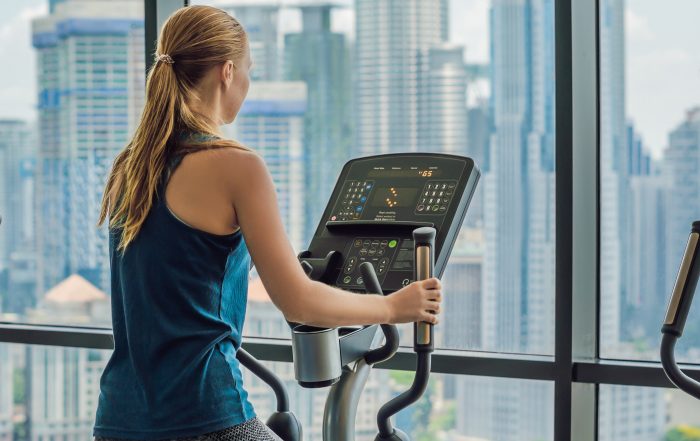 Woman exercising on an elliptical in a multi-family building