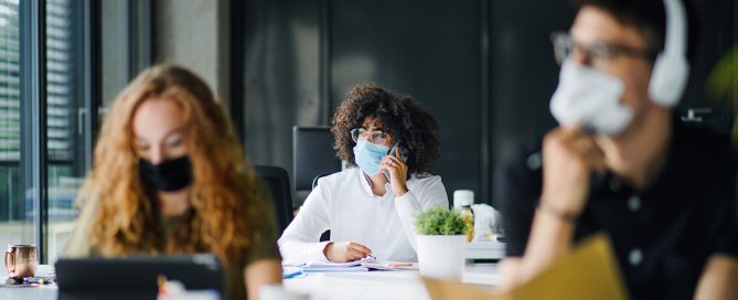Young people with face masks back on campus amid coronavirus pandemic